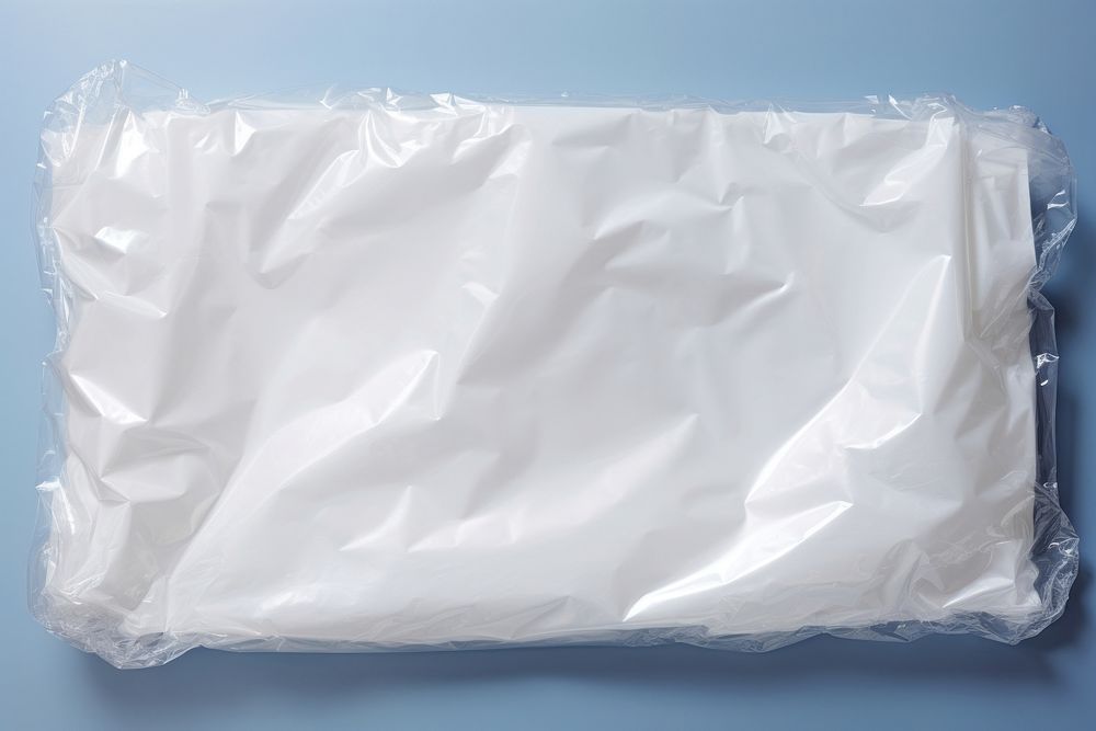 Plastic wrapping over a cloud white bag crumpled.