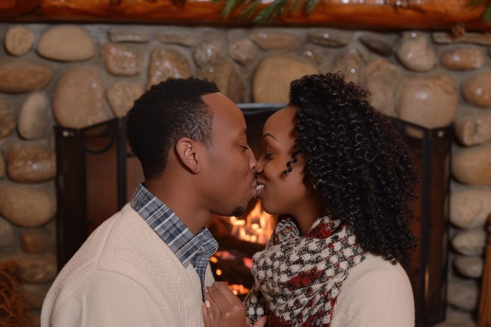 Black couple kissing fireplace portrait romantic.
