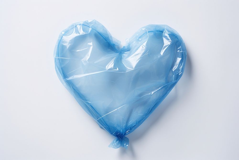 Plastic wrapping over a heart white background symbol candy.