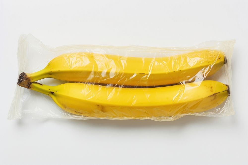 Plastic wrapping over a rotten banana plant food white background.