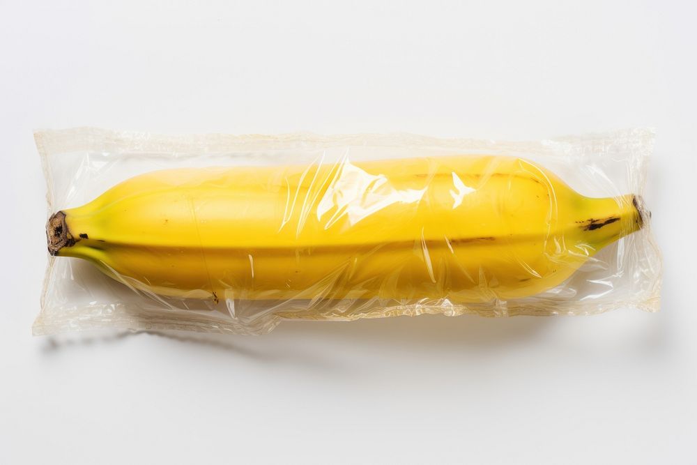 Plastic wrapping over a rotten banana food white background freshness.