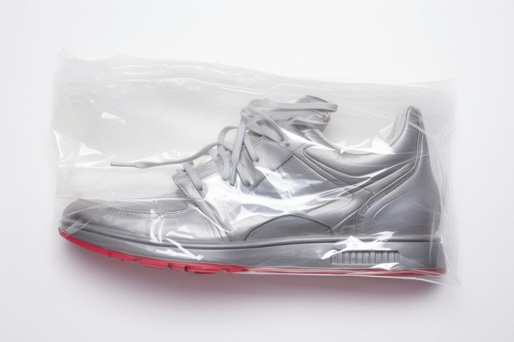 Plastic wrapping over an old sneaker footwear white shoe.