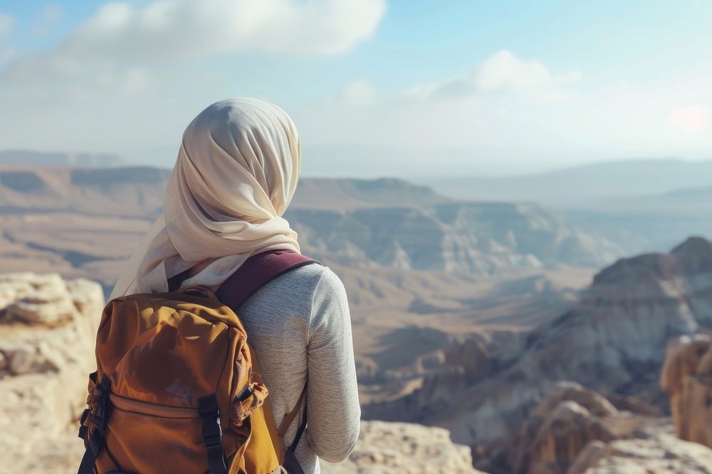 Middle eastern woman backpack landscape mountain.