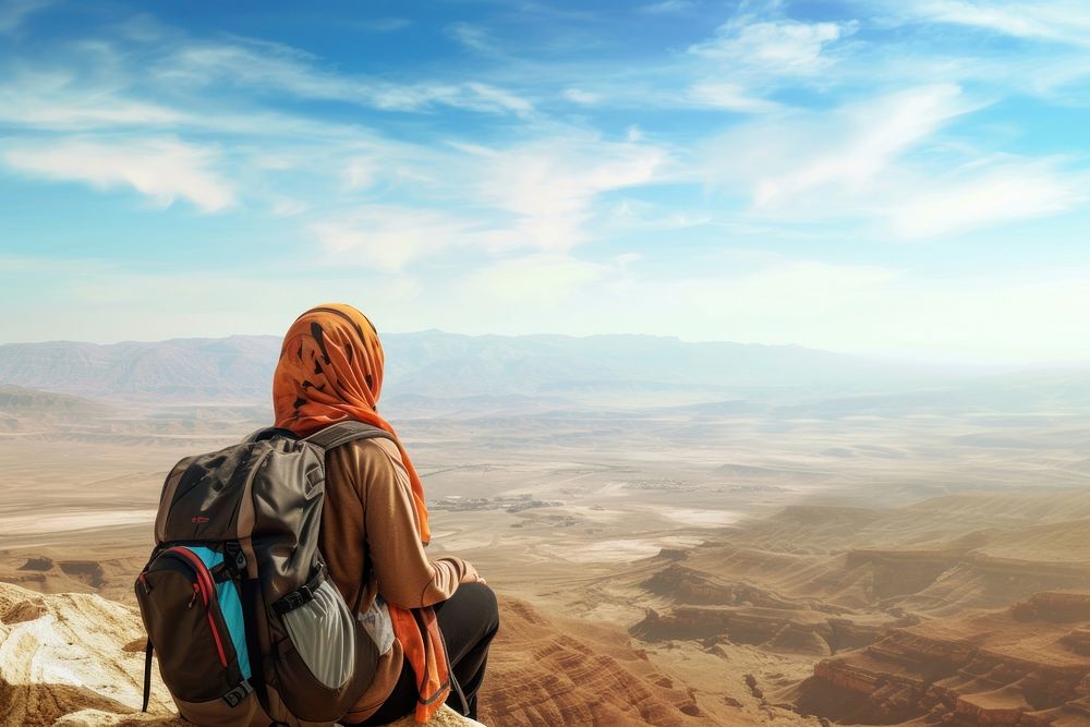 Middle eastern woman backpack landscape mountain.