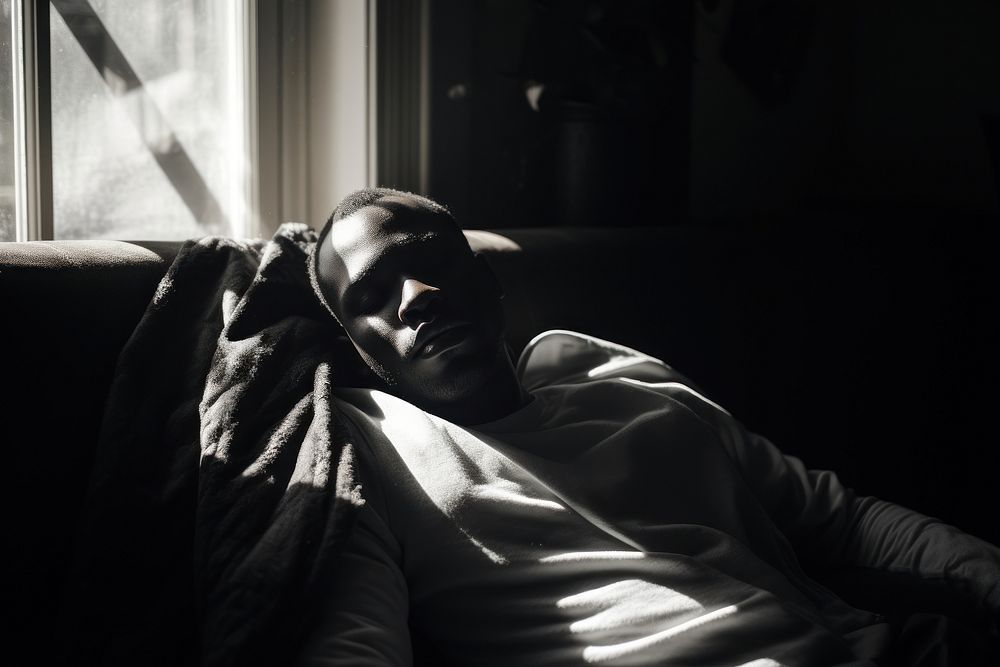 Black sick man furniture sleeping portrait.