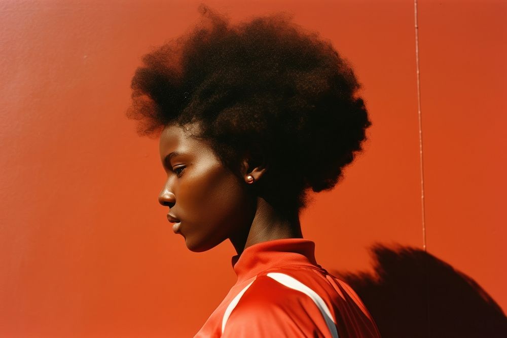 A black woman wearing sport wear adult red hairstyle.