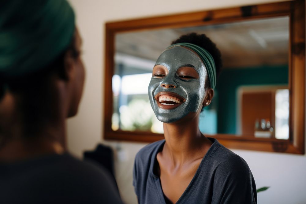 Applying face mask smiling adult woman.