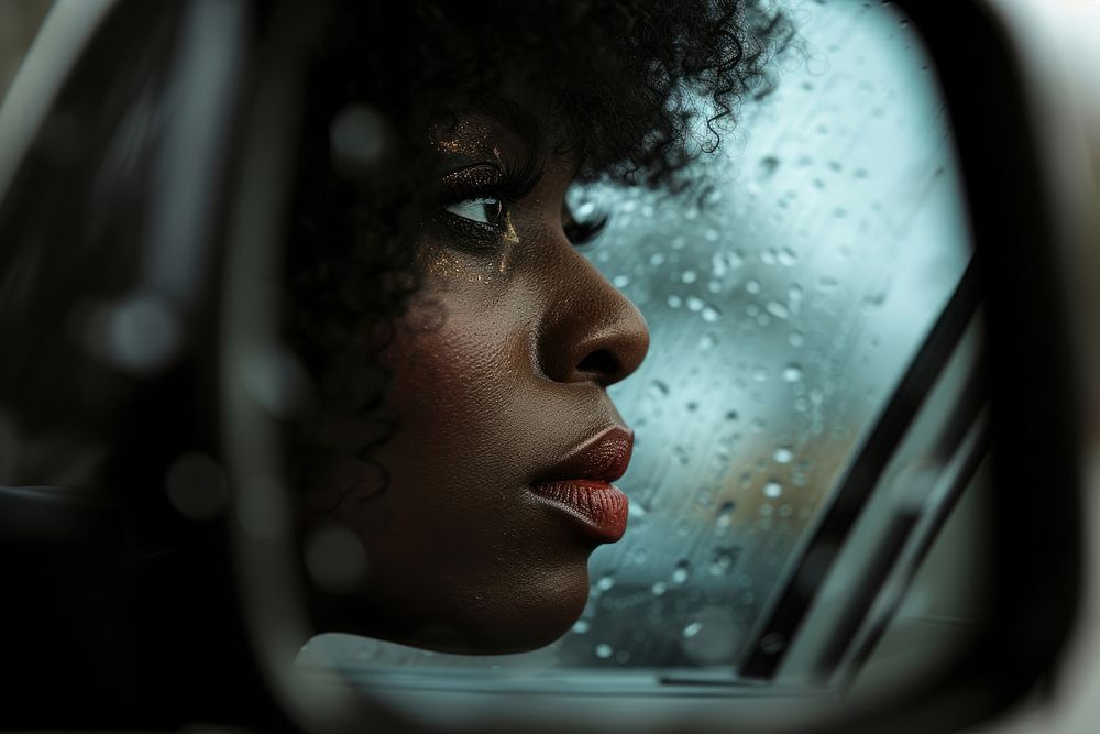 Black woman in Side view mirror photography reflection portrait.