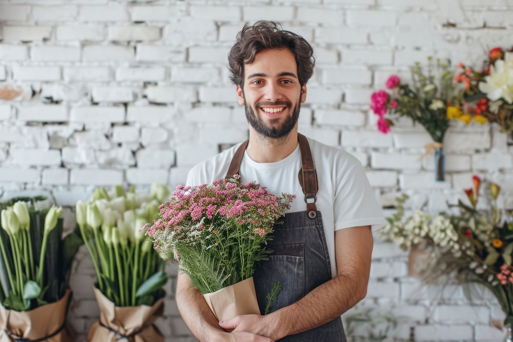 Young man florist working adult plant.