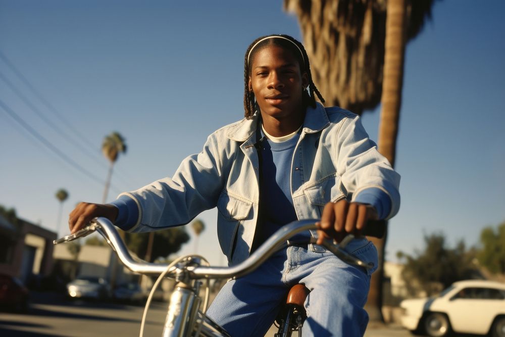 Young black man riding lowrider bike portrait bicycle vehicle.