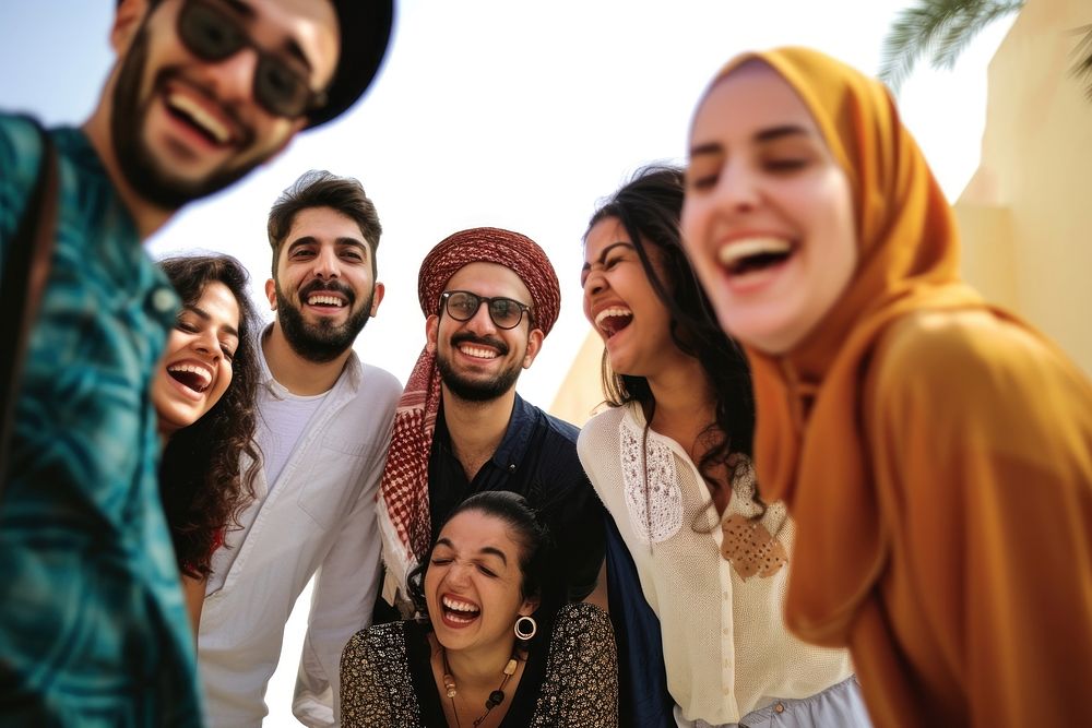 Group of happy Middle eastern friends and laughing people adult togetherness.