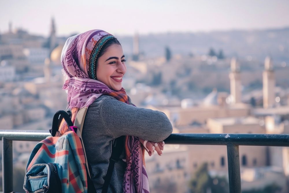 Happy Middle eastern girl traveler on the viewing architecture cityscape building.