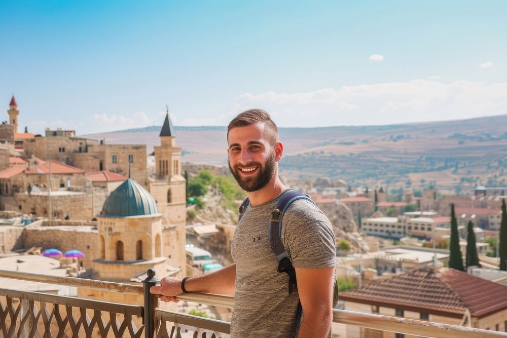 Happy Middle eastern man traveler architecture cityscape outdoors.