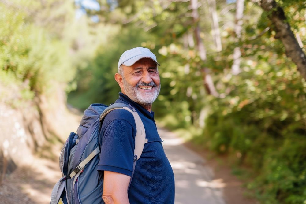 Senior Middle eastern man hiking outdoors backpack walking travel.