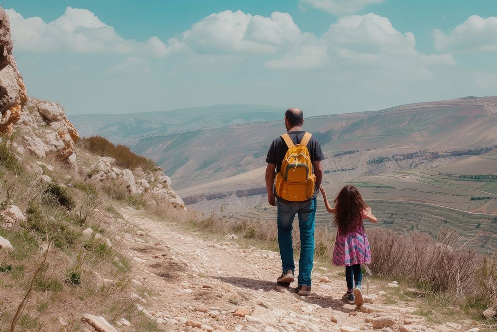 Middle eastern father and daughter travelling backpack walking hiking.