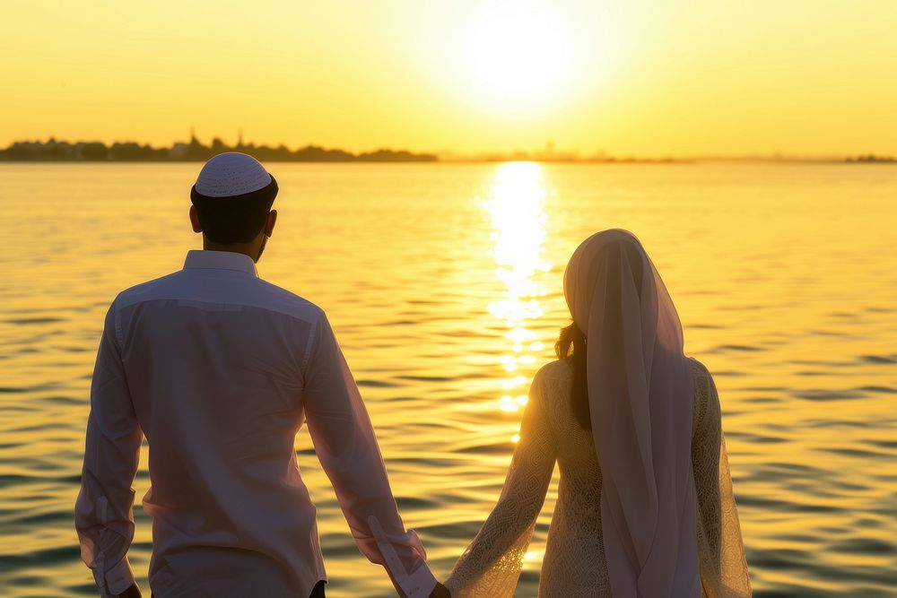 Young wealthy middle eastern couple standing wedding sunset.
