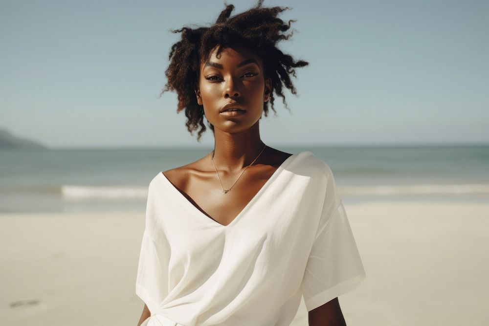 Black woman wear minimal beach fashionable wearing pale white outfit portrait adult contemplation.