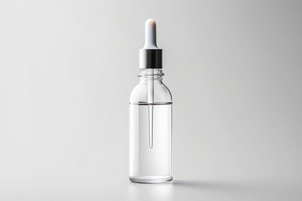 Glass dropper bottle cosmetics perfume white background.