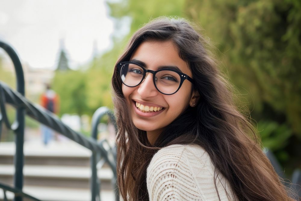 Middle-eastern college girl glasses portrait outdoors.