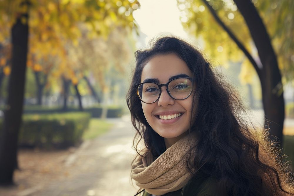 Middle-eastern college girl portrait glasses outdoors.