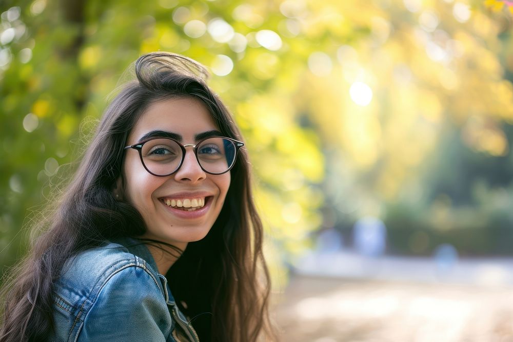 Middle-eastern college girl portrait glasses outdoors.