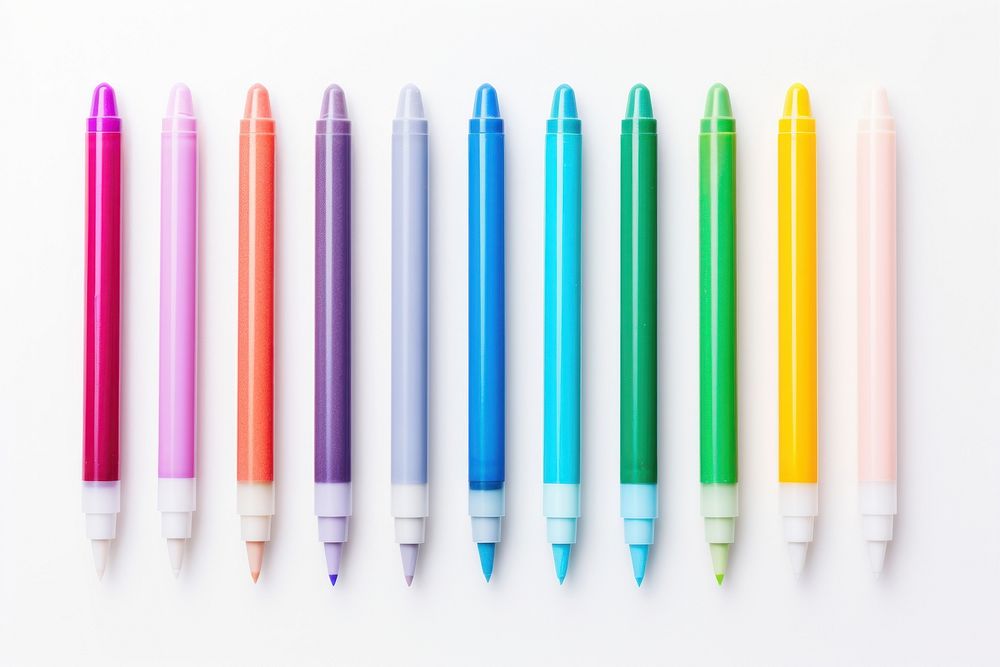Multi colored markers pen white background arrangement.
