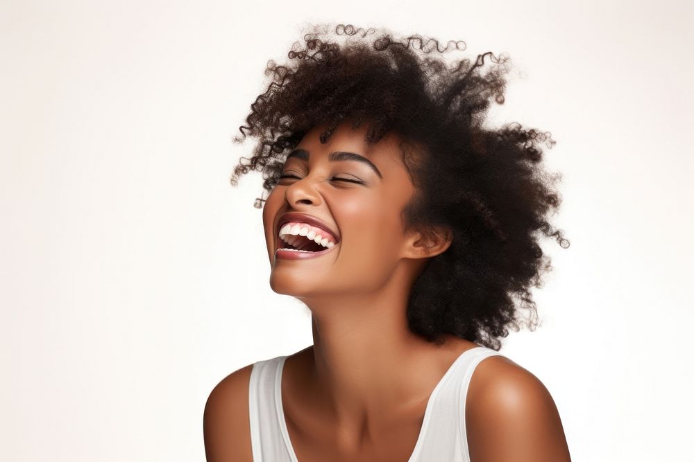 Portrait of black woman laughing in studio smile adult white background.