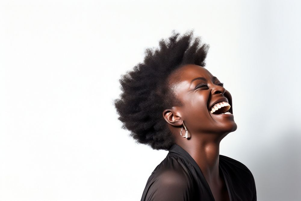 Portrait of black woman laughing in studio adult white background individuality.