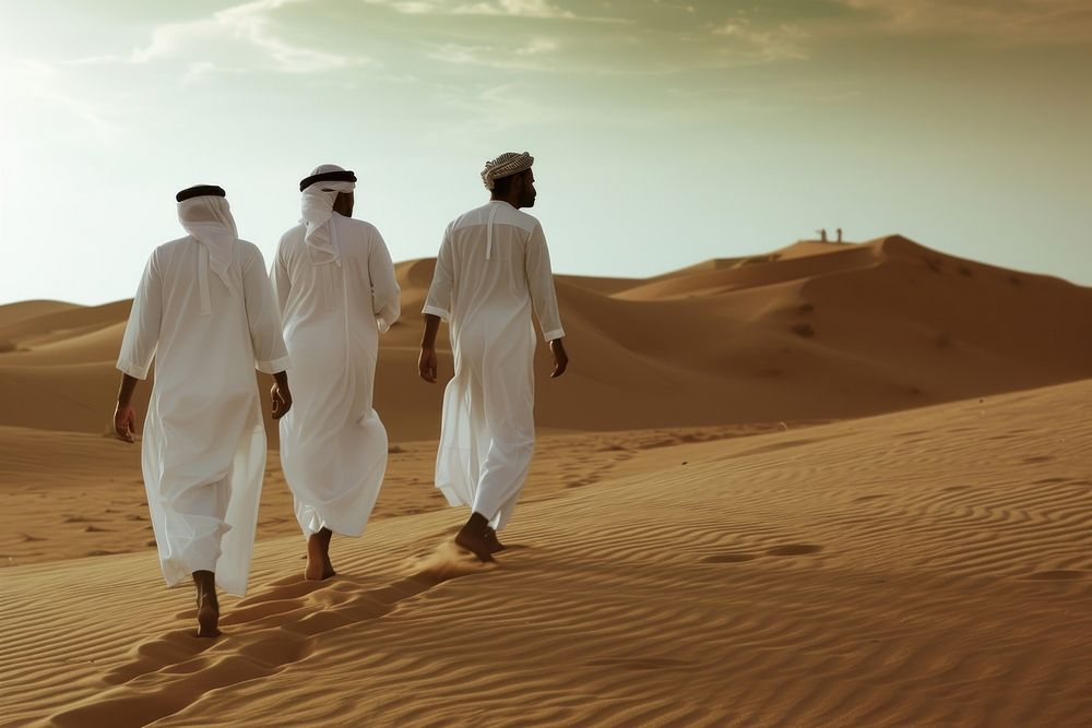 Middle Eastern Men walking desert outdoors.