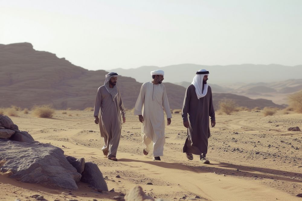 Middle Eastern Men walking standing desert.