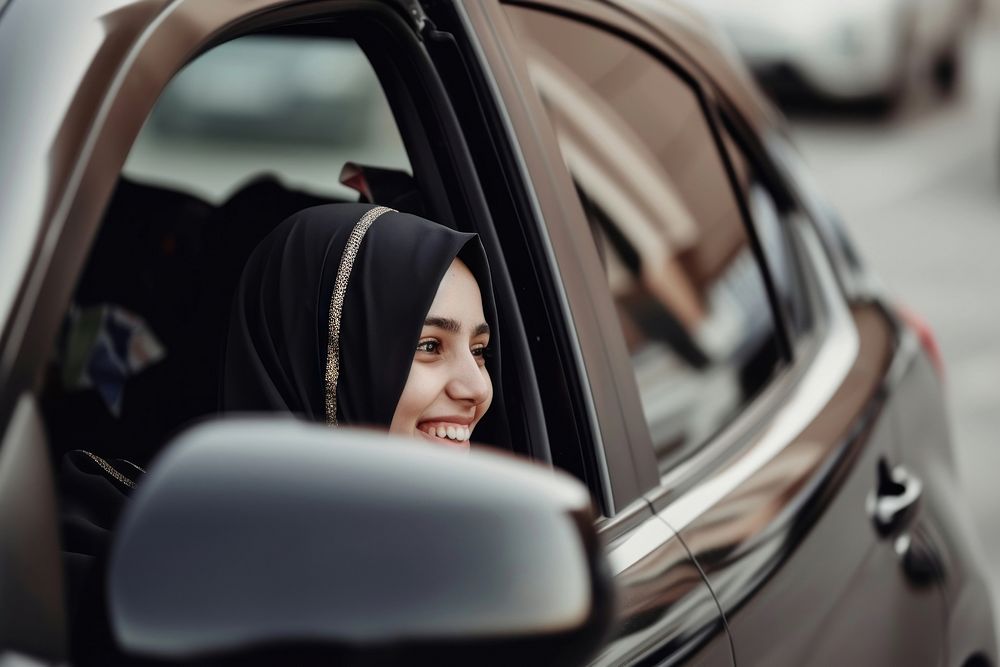 Smiling millennial arab female car vehicle journey.