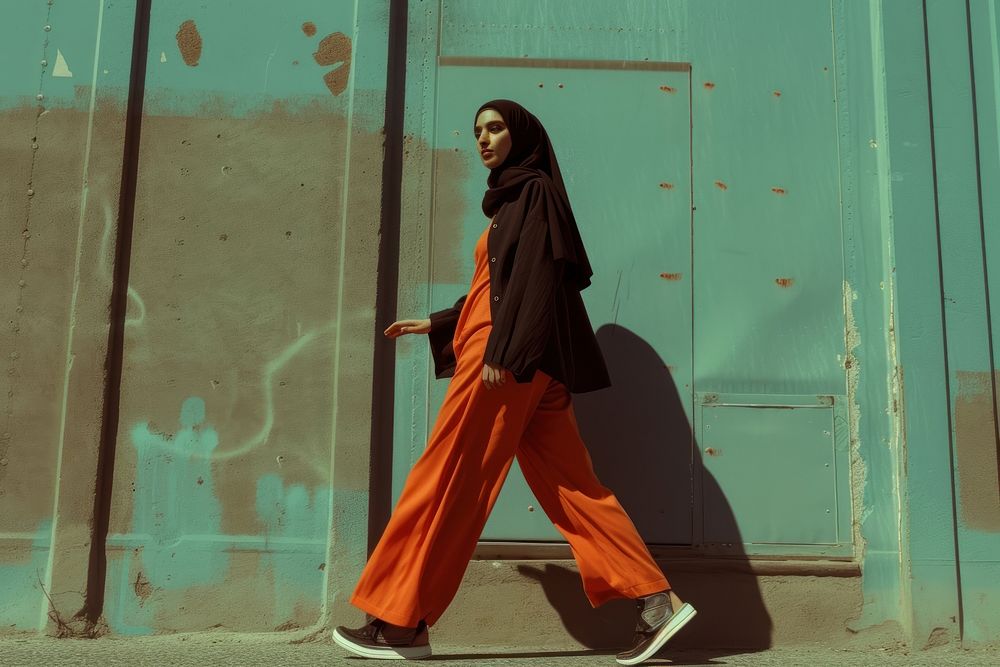 Middle Eastern woman walking fashion portrait street.