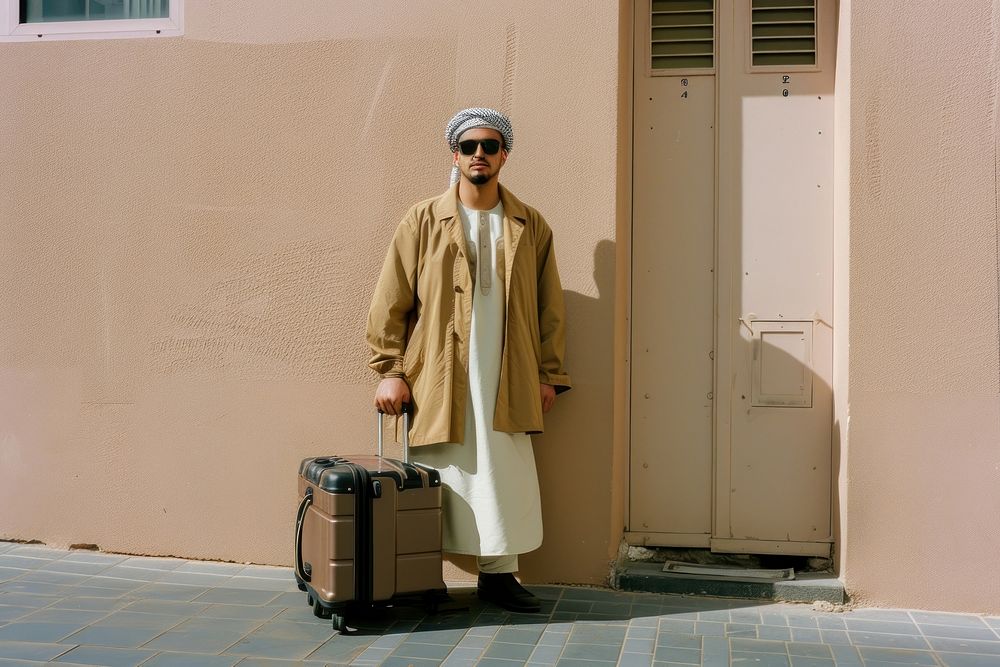 Middle Eastern man happy face suitcase portrait glasses.
