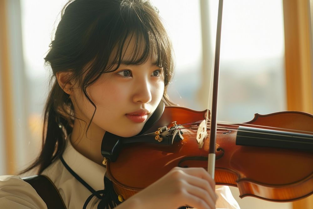 Japanese high school woman violin musician concentration.