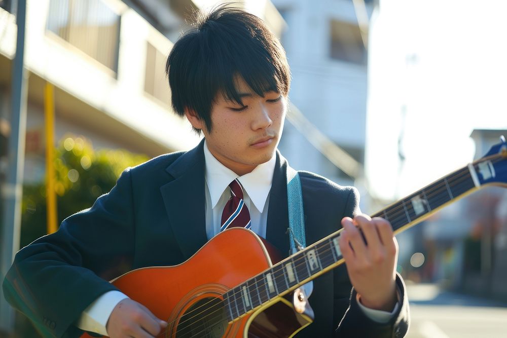 Japanese high school man guitar musician concentration.