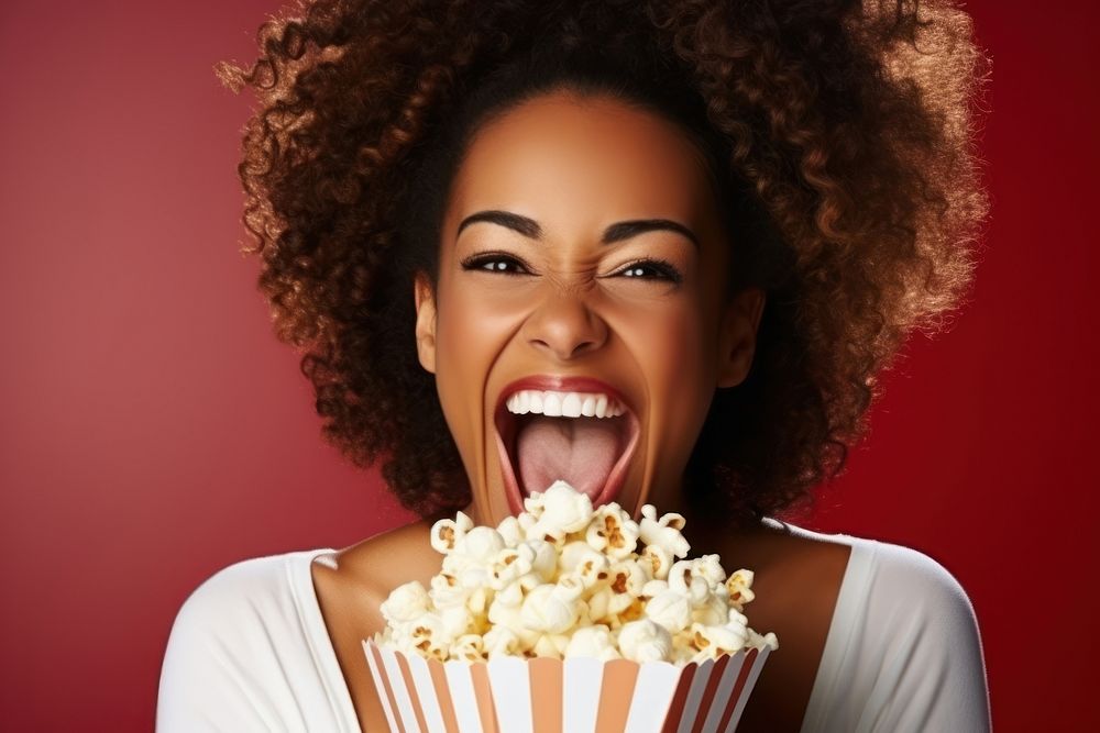 Black woman holding popcorn portrait smiling adult.