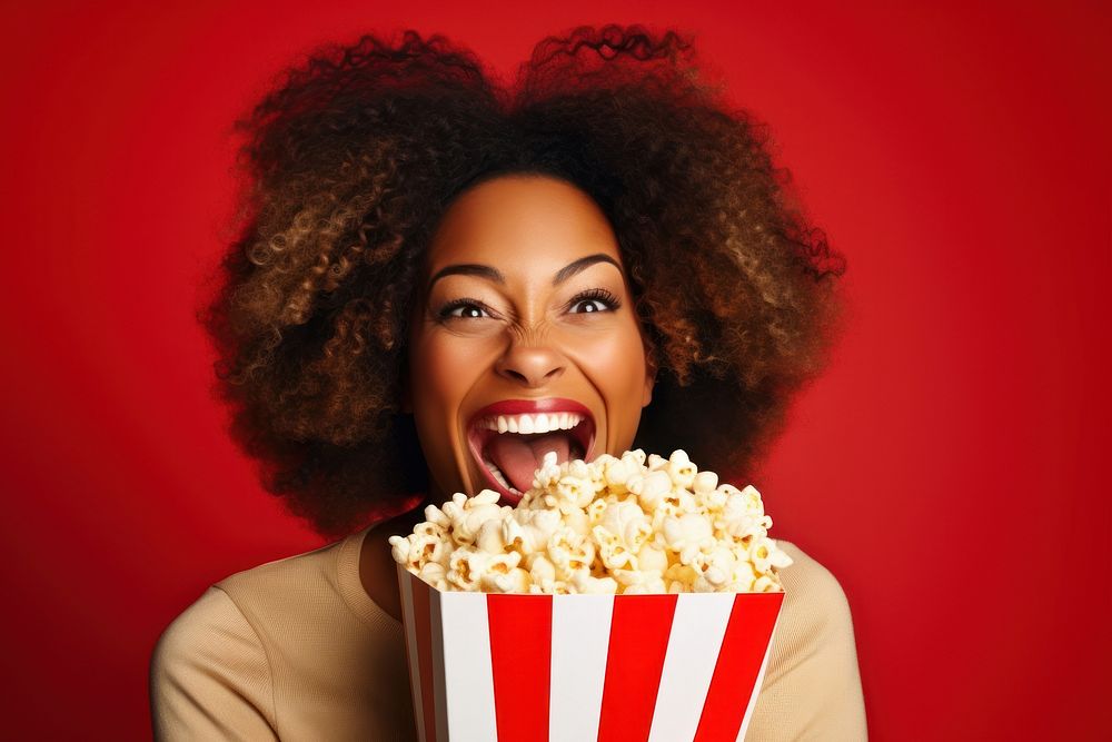 Black woman holding popcorn portrait smiling adult.