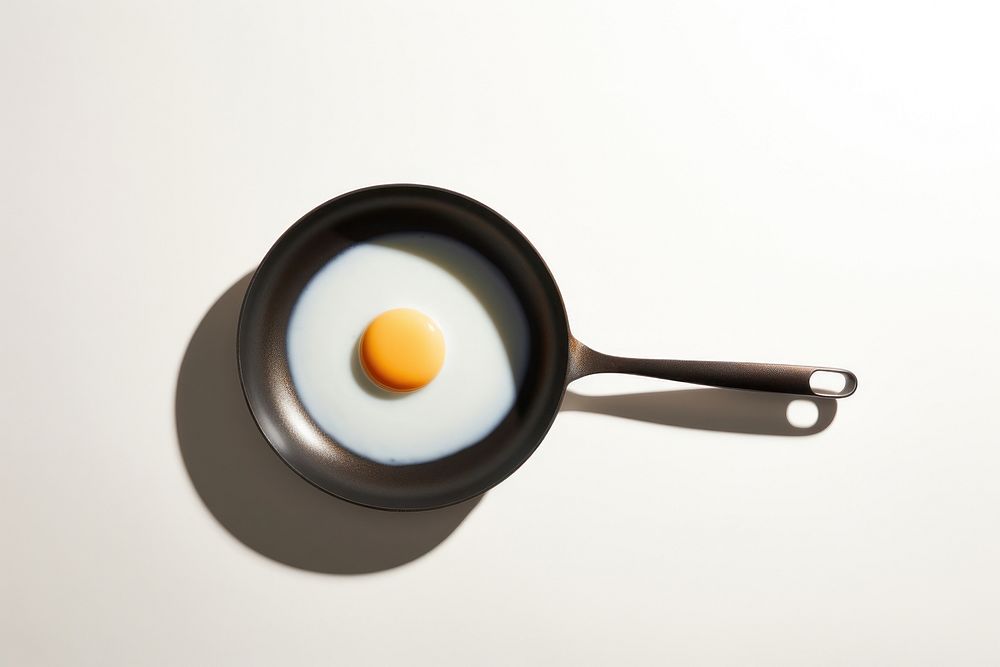 Fried egg on pan simplicity tableware freshness. AI generated Image by rawpixel.
