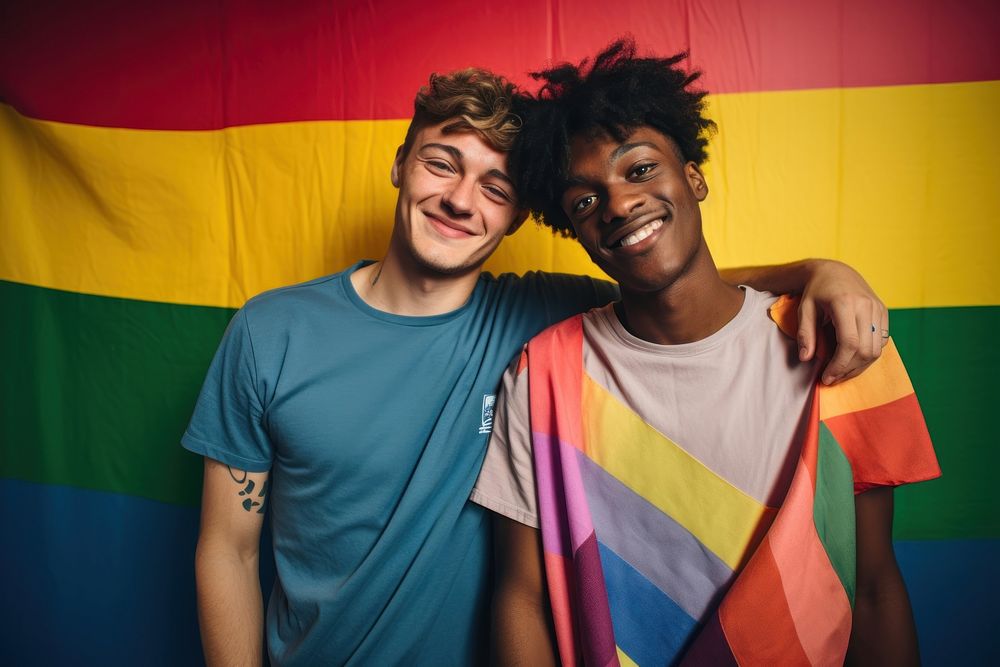 Smiling gay couple standing laughing portrait.