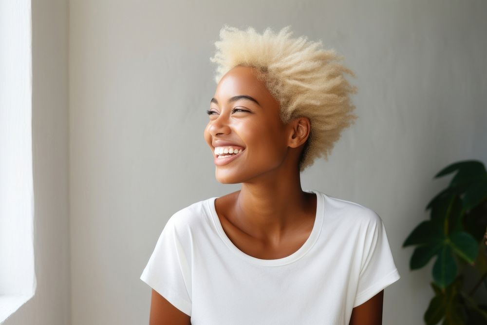 A black woman talking to someone blonde smile adult.
