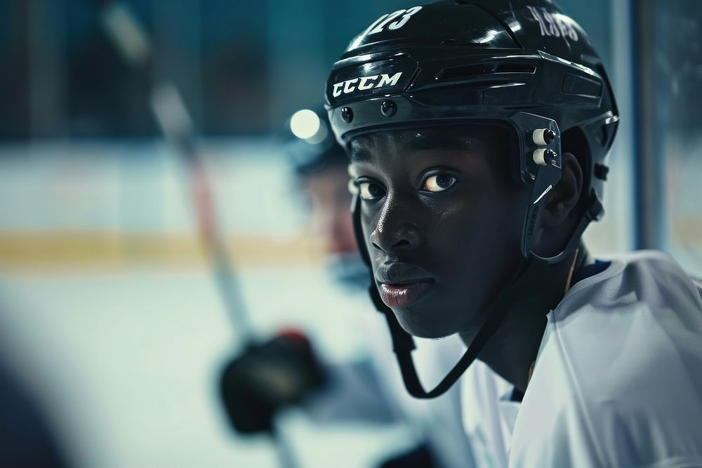 Black man player hockey helmet.