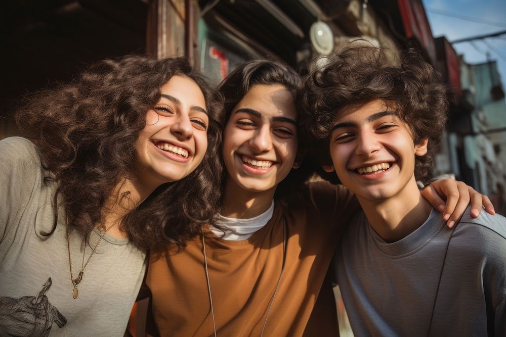 Middle eastern teenagers laughing smile togetherness.