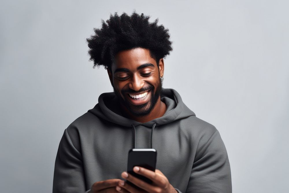 Cheerful black man using phone adult photo portability.