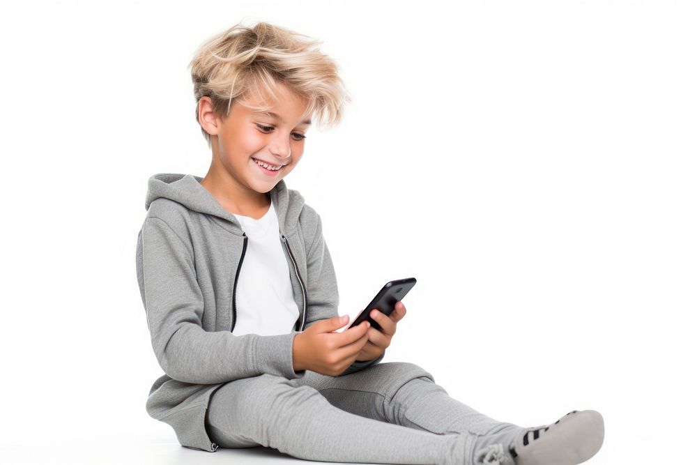 Cheerful kid using phone sitting white background portability.