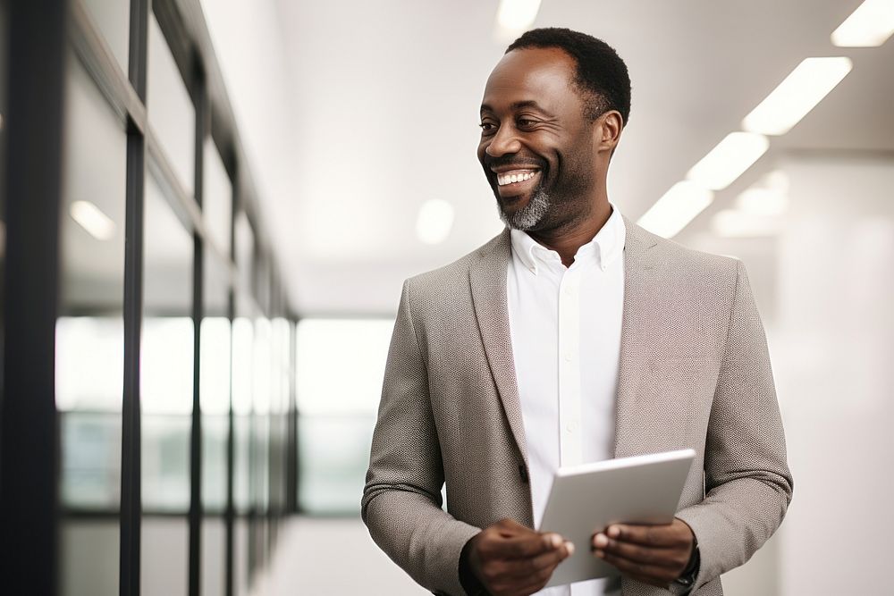 African business man standing computer smiling.