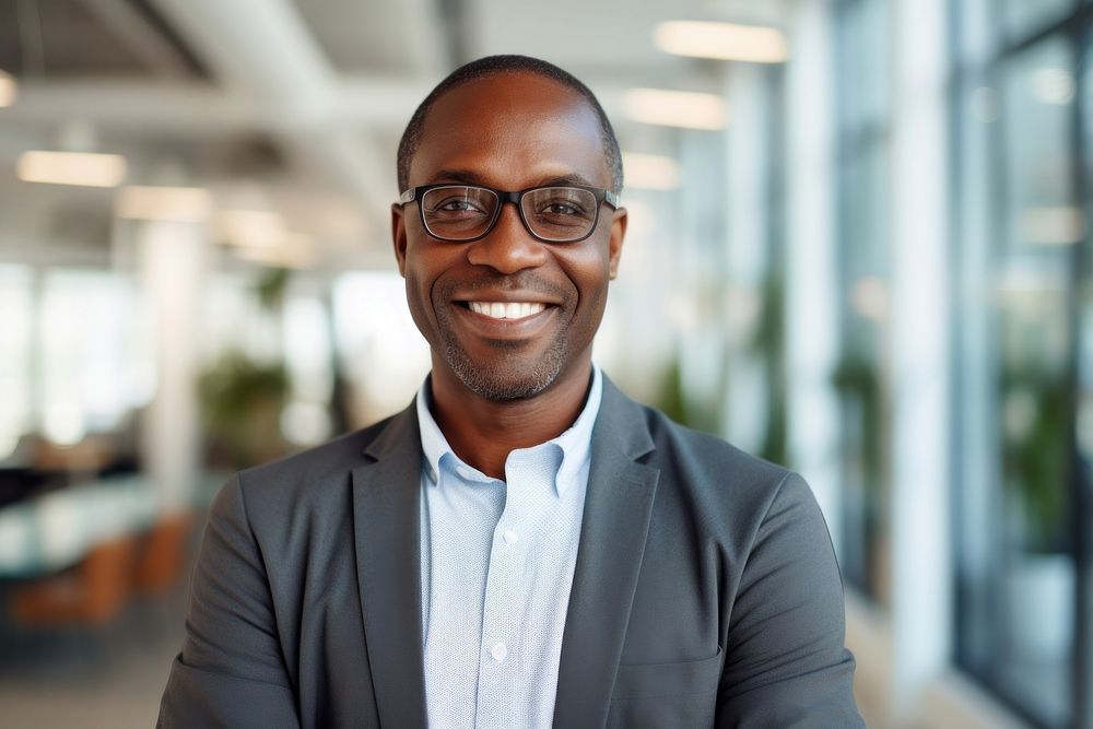 African business man standing portrait glasses.