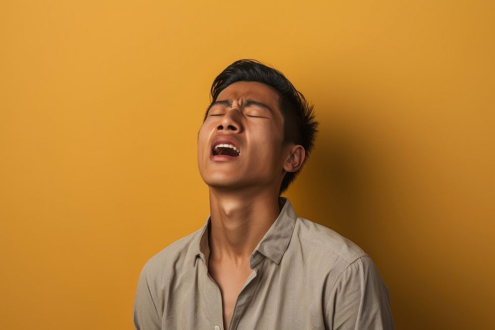 Vietnamese man yawning adult frustration.
