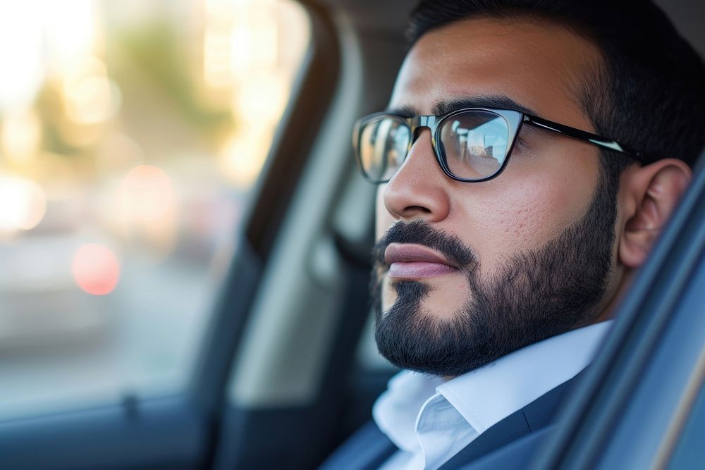 Arab business man on a car glasses looking window.