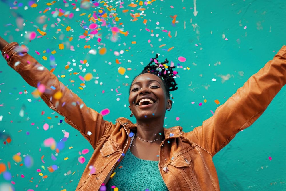 Cheerful black woman with confetti enjoying cheerful adult celebration.