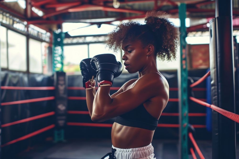 African American woman boxing sports gym.